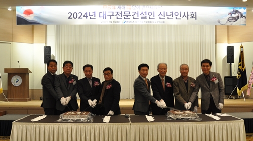 ◇김석 회장(오른쪽 네 번째) 등 신년인사회 참석자들이 기념떡을 자르고 있다.
